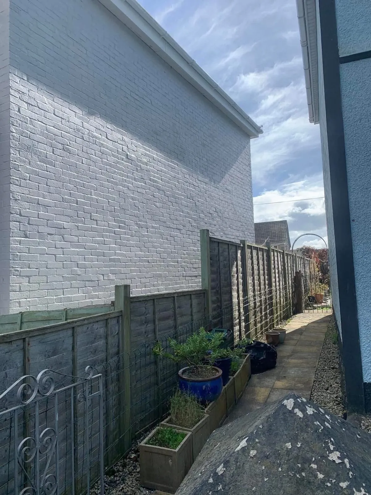 Freshly painted brick wall after preparation and masonry paint in Wadebridge